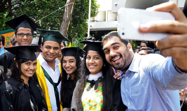 IT Minister K. Taraka Rama Rao attends a selfie session with students at the Muffakham Jah College of Engineering and Technology graduation day  in Hyderabad. Photo: The Hindu